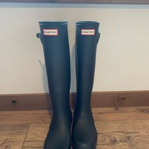 Tall black hunter boots.